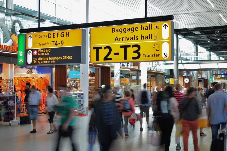 Travellers walking through an airport terminal
